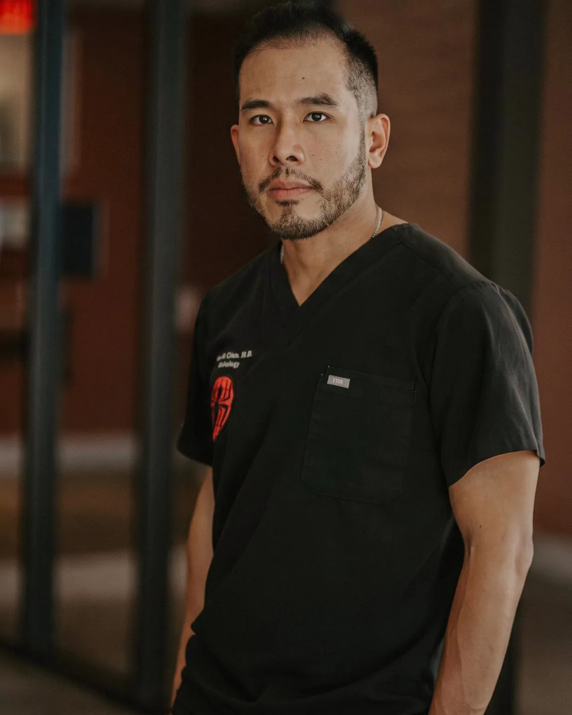 Alan Chen, MD, in scrubs