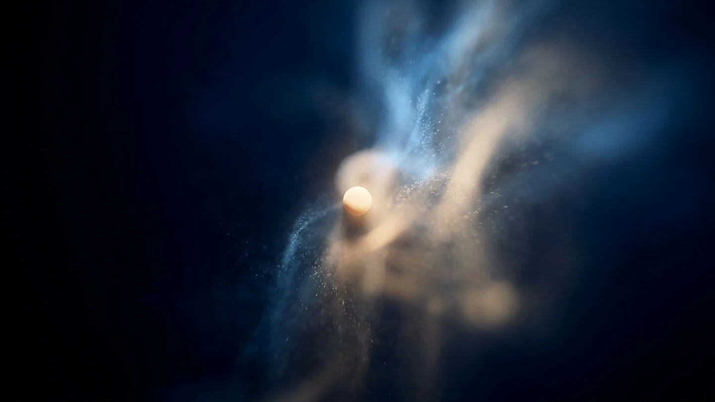 A single point of warm light held in a dark field